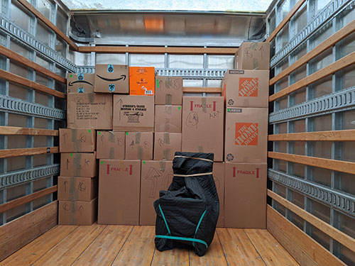 Fully-packed boxes are being loaded into a Broad Street Movers truck as another office move in the Philly area begins