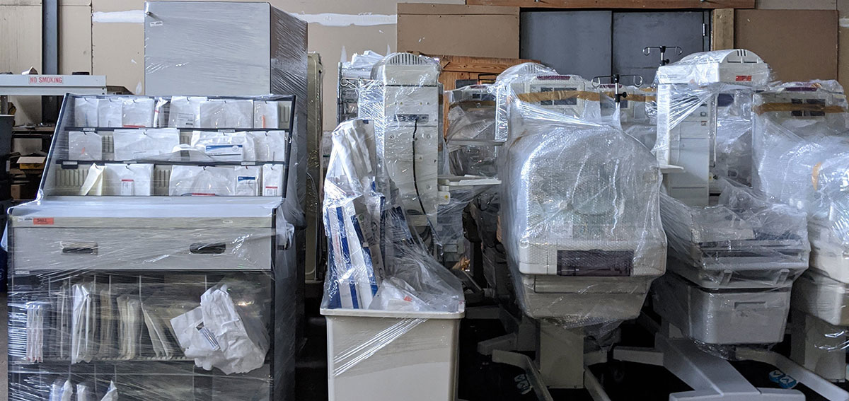 Several machines and office furniture carefully wrapped in plastic for a corporate relocation