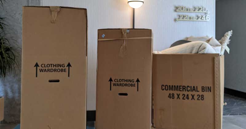 Very large boxes on dollies in the modern lobby of an apartment building, ready to be loaded into the moving truck for the next local move in the Philly area