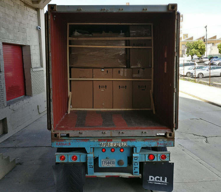 Broad Street Movers handle the unloading of a rental truck, a task requiring specialized moving equipment to safely transport the items