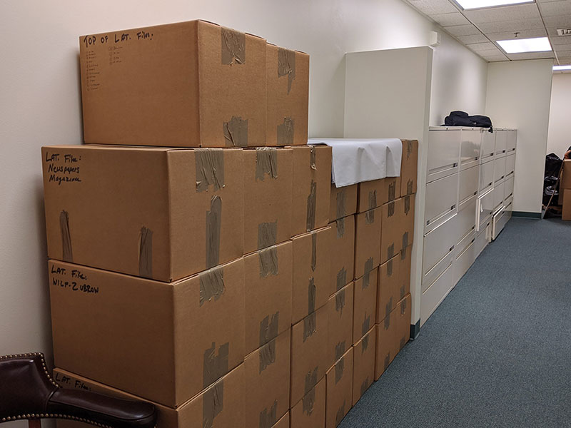 Several stacks of neatly packed boxes in a office during a corporate relocation move