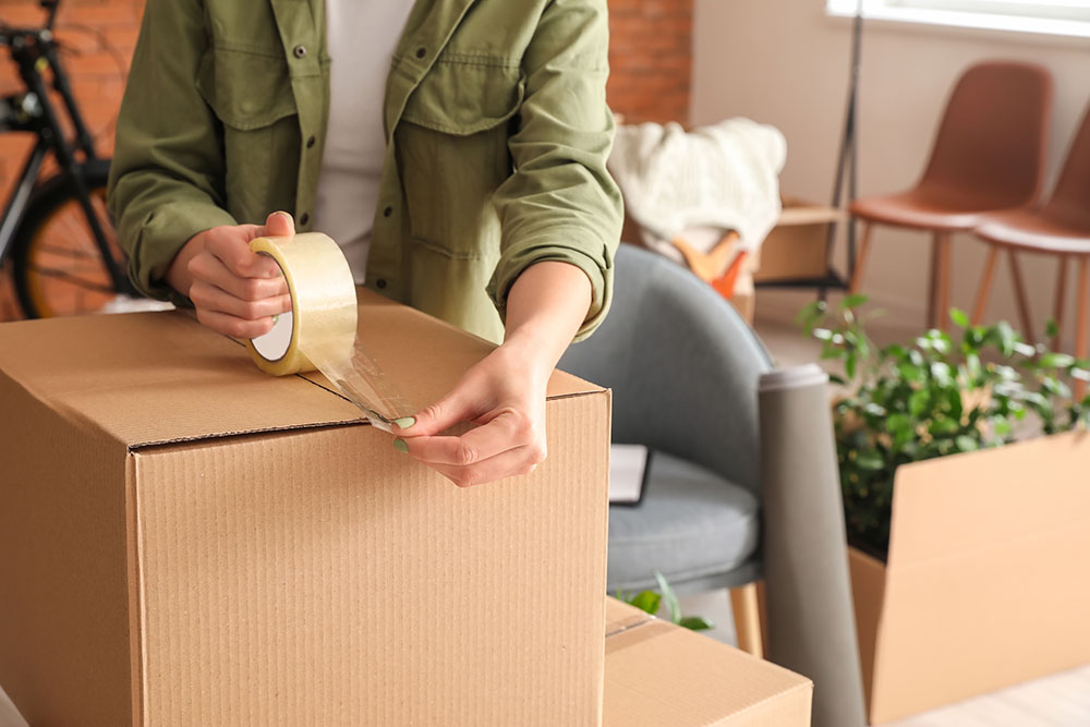 Woman packing a box for an upcoming move in Philadelphia